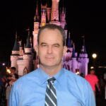 Speaker Vance Morris stands in front of the Disney Castle