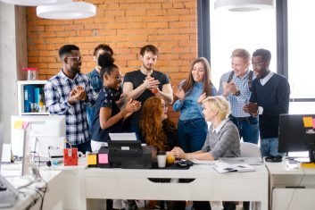 office workers warmly greeting and welcoming new partner